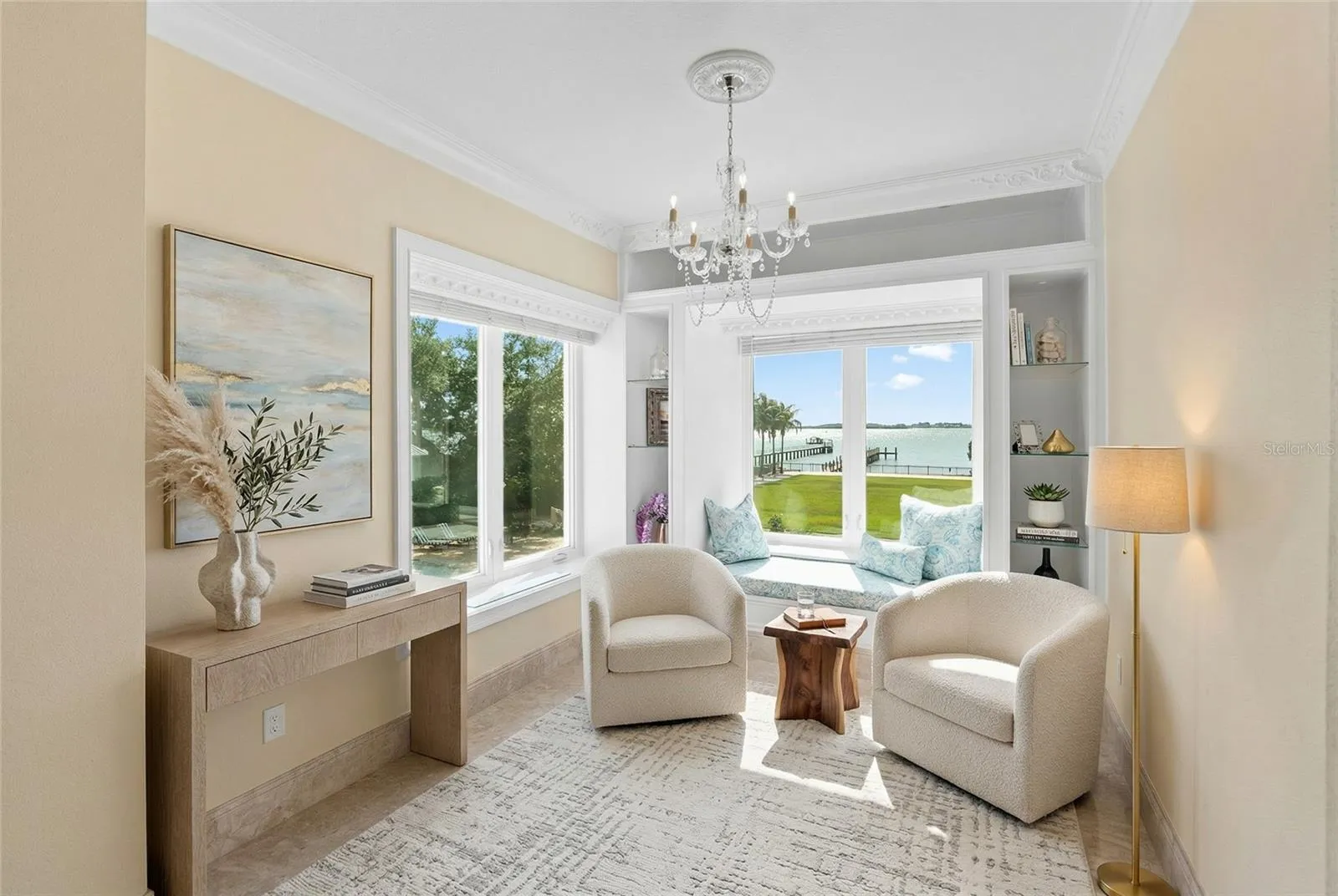 Elegant sitting area with a window seat to curl up to a good book and relax in the Primary suite with water views.