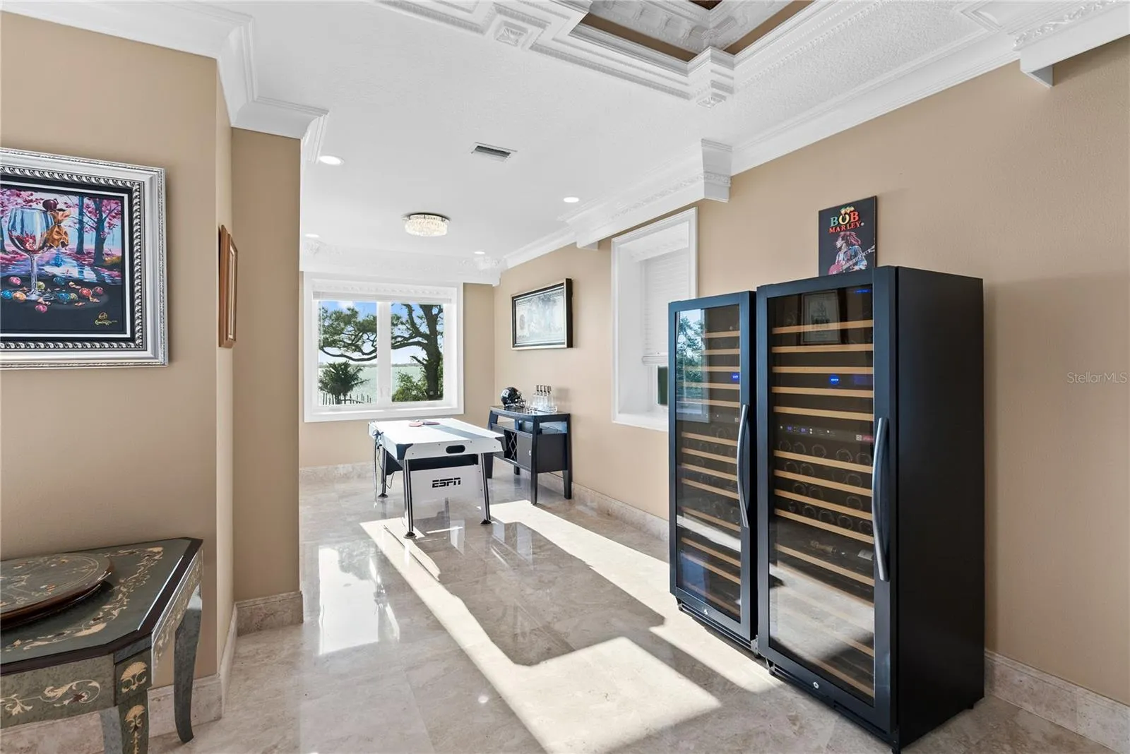 Expansive room with two ornate coffered ceilings—perfect for a pool table or game lounge.