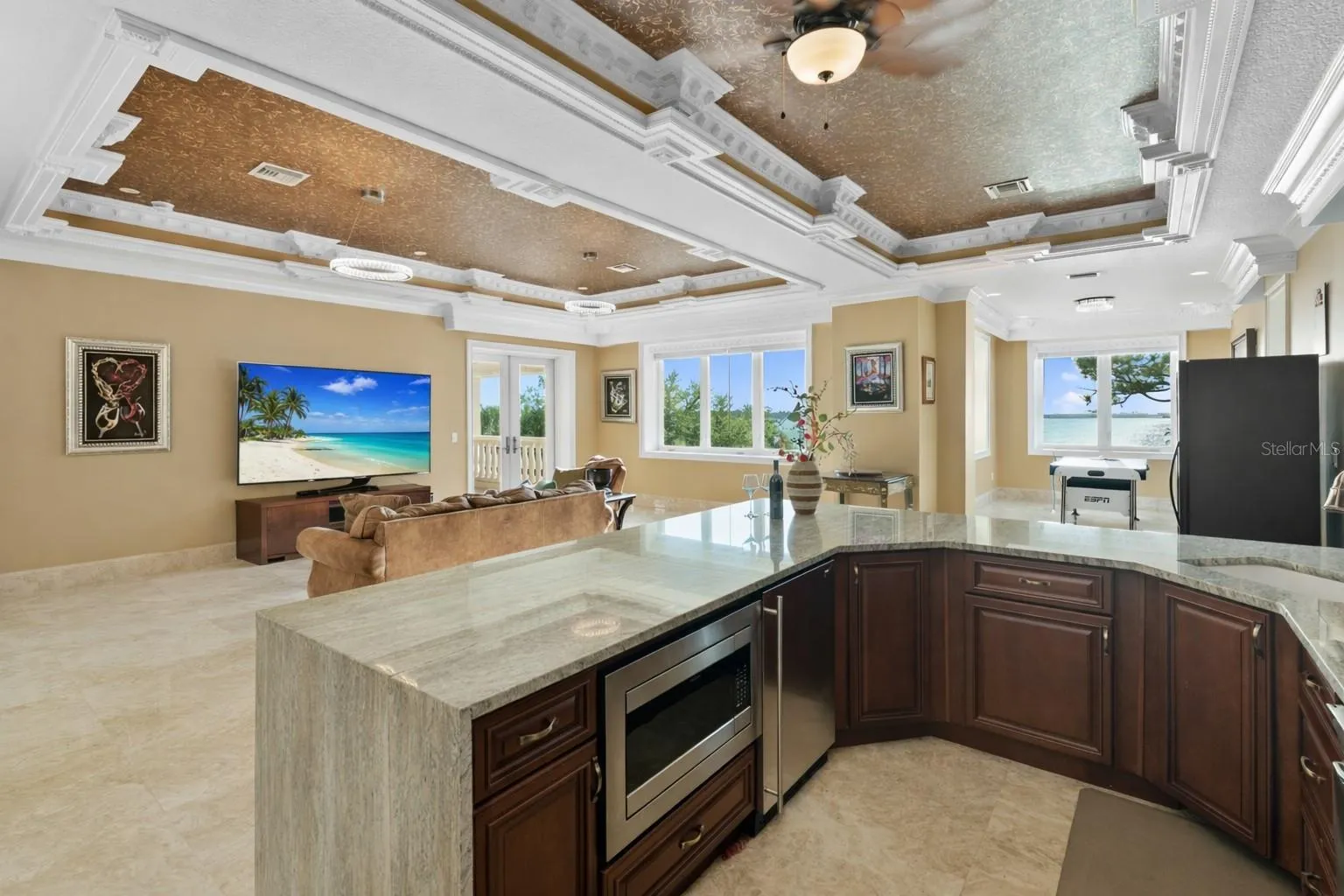 Quartzite full bar with microwave, a Scotsman specialty icemaker and large full screen TV with breathtaking sunset views and a balcony overlooking the pool and Boca Ciega Bay
