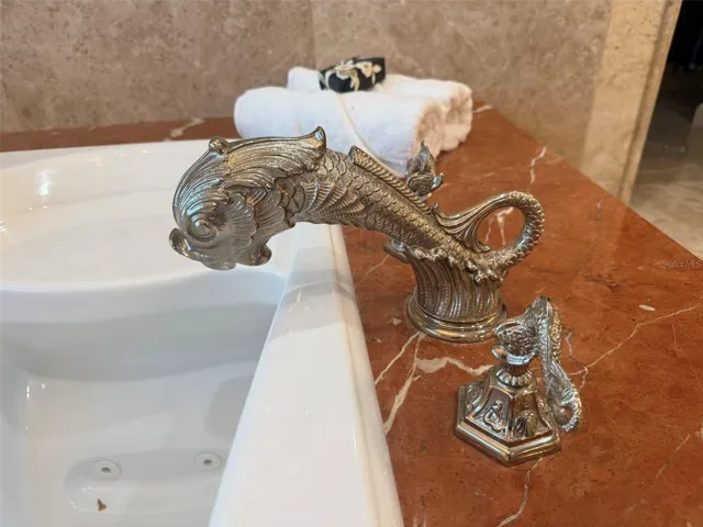 Phylrich Dolphin fixtures, a large sauna, soaking tub, multi-jet full-body rain shower, multiple vanities, and expansive custom closets
