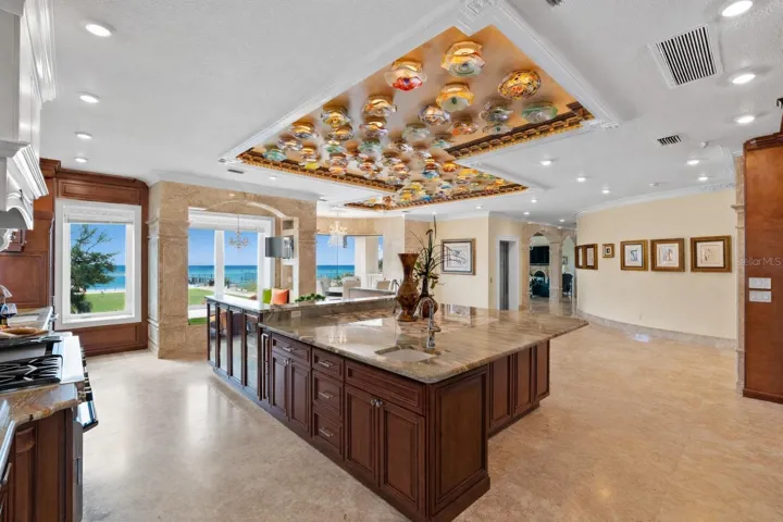 Chef’s kitchen with a full suite of Thermador appliances and statement onyx island.
