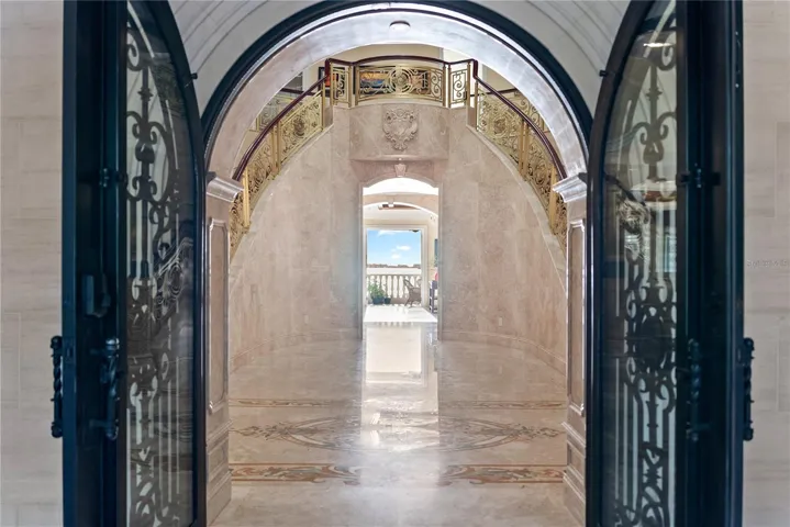 Arched Iron doors welcome you to Palazzo Sul Mare!   Opens to water views and a gallery corridor designed for art display and dramatic transitions between spaces.