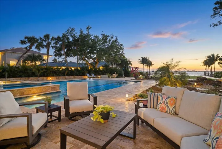 Resort-style pool and waterfront living with sunset views.