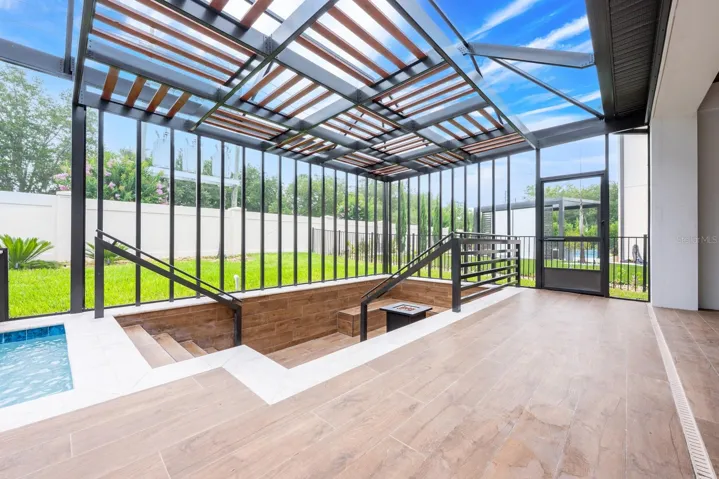 Covered lanai overlooks a private screened pool.