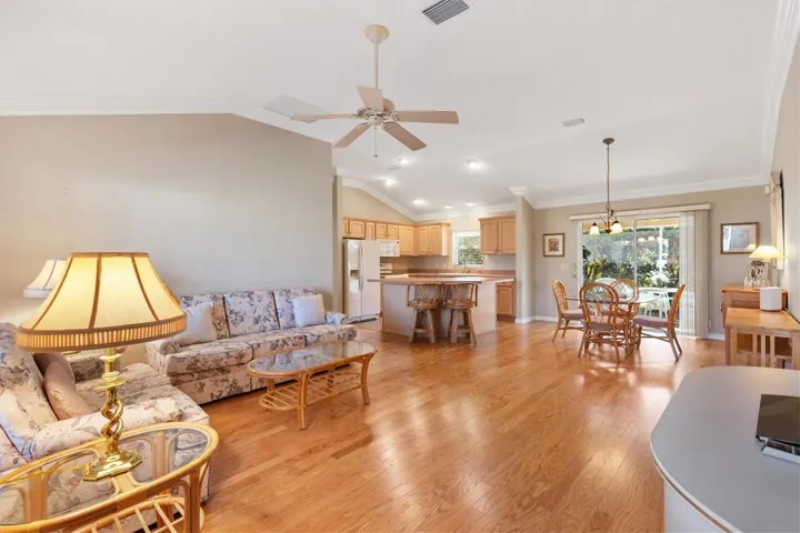 Living room, dining room and kitchen.  Hardwood floors with tile in kitchen and crown molding throughout.
