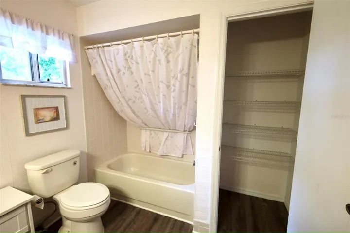 2nd bedroom full bathroom with closet and shelves