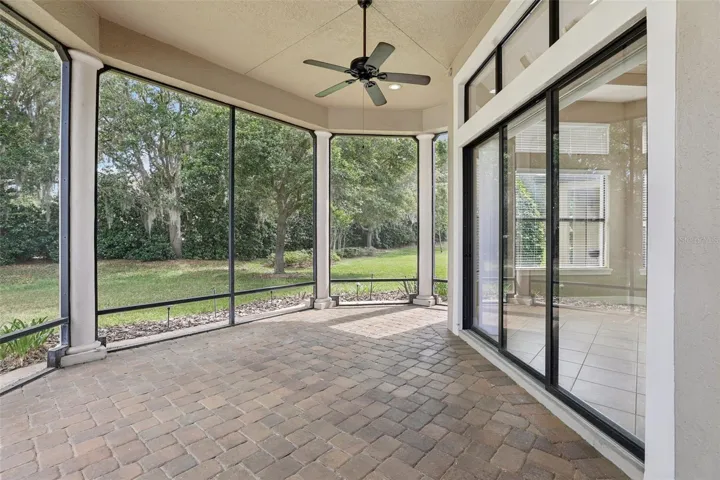 Back screened patio with sliders to Family room