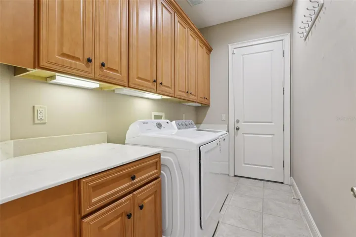 Huge laundry room plenty of cabinets and storage spaceentry to garage