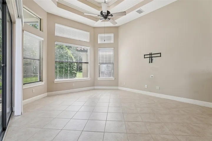 Looking into Dining/kitchen family room combo with Tray ceilings and recessed lighting