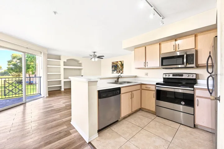 The Living Room features built-in shelving and sliding glass doors that lead to a PRIVATE BALCONY.