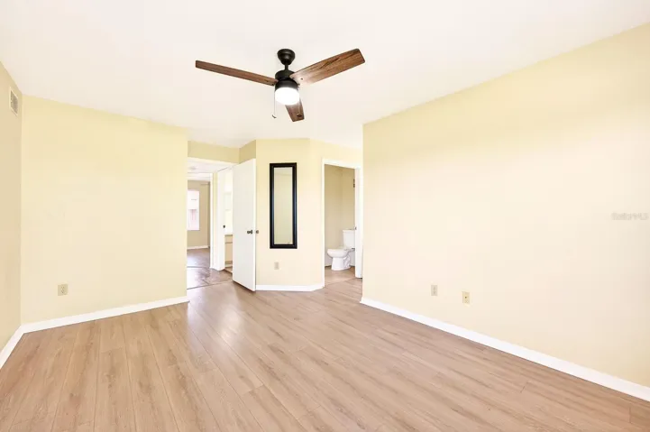 The Primary Bedroom continues the theme of comfort and views, featuring wood-look vinyl flooring, a walk-in closet, and PRIVATE ACCESS to the full bath.