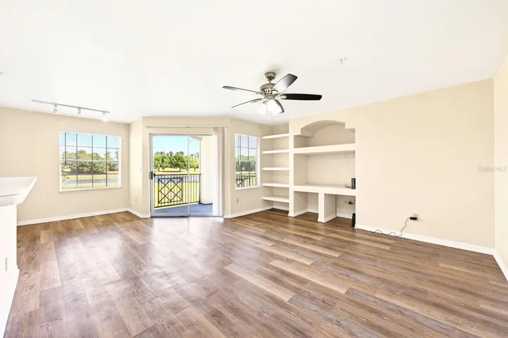 The Living Room features built-in shelving and sliding glass doors that lead to a PRIVATE BALCONY.