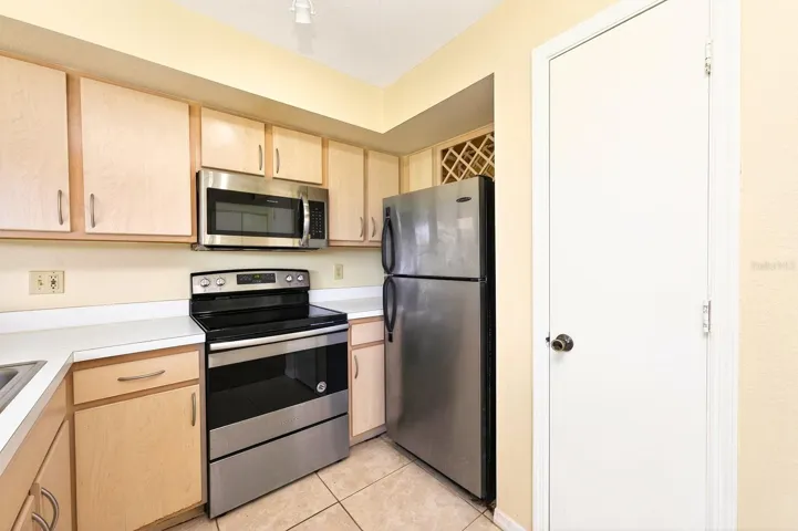 The Kitchen is both functional and stylish, complete with stainless steel appliances, a closet pantry, and a CONVENIENT BREAKFAST BAR for casual dining.