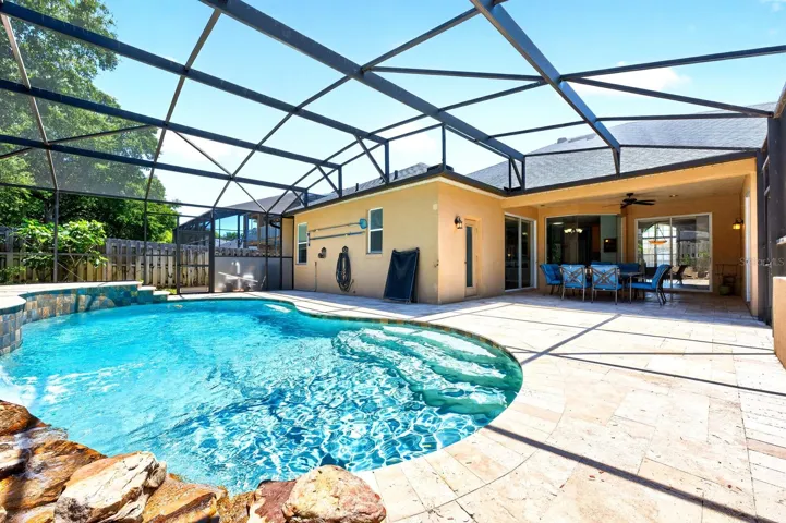 Step outside to your personal Florida retreat featuring a private SCREENED POOL with a STACKED STONE WATERFALL, a large COVERED LANAI, and plenty of space to relax or host weekend gatherings!