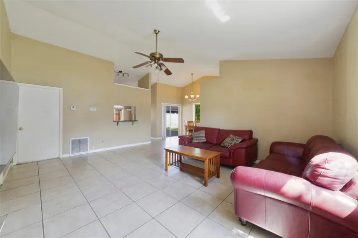 Step inside to find EASY-CARE TILE FLOORING throughout and a bright, open Living Room highlighted by a SOARING VAULTED CEILING that enhances the sense of space.