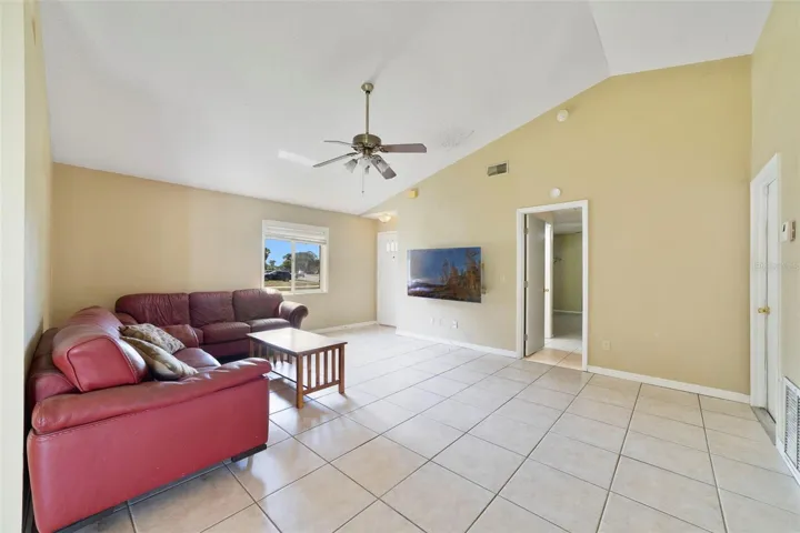 Step inside to find EASY-CARE TILE FLOORING throughout and a bright, open Living Room highlighted by a SOARING VAULTED CEILING that enhances the sense of space.