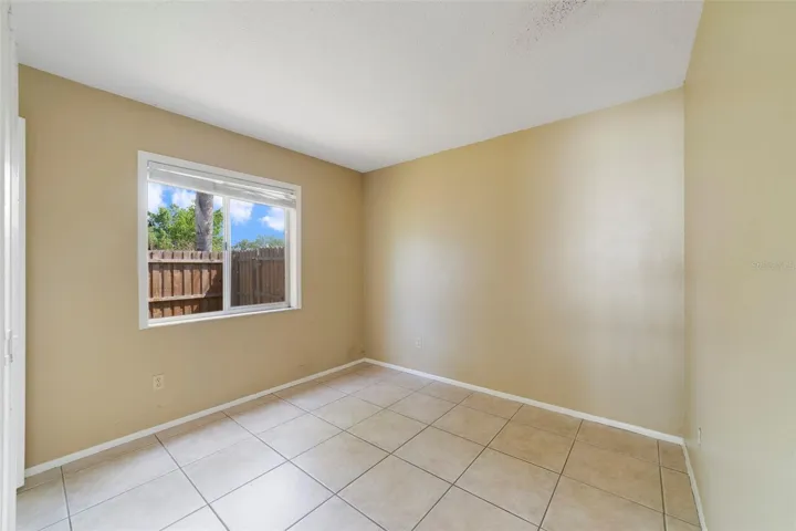 The second bedroom is conveniently located near the home's SECOND FULL BATHROOM, making it ideal for guests, family members, or a home office.