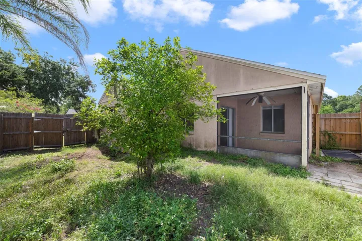 The back patio provides a place to enjoy your morning coffee, unwind in the evening, or envision the possibilities for the FENCED BACKYARD.