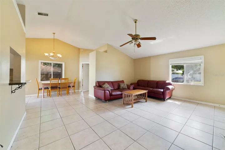 The adjoining Kitchen is filled with NATURAL LIGHT and features a convenient PASS-THROUGH WINDOW overlooking the Living Room—perfect for staying connected with family and guests.