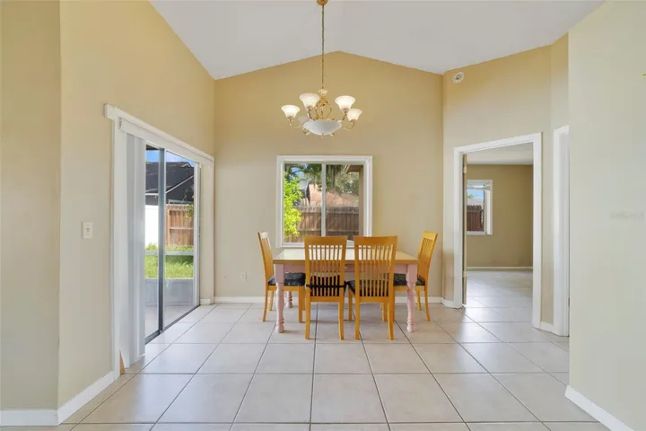The Dining area is positioned just off the Kitchen and features sliding glass doors that lead to the SCREENED PATIO, creating an effortless indoor-outdoor flow.
