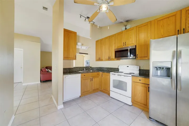 The Kitchen features ample cabinetry and solid surface countertops for meal prep and storage.