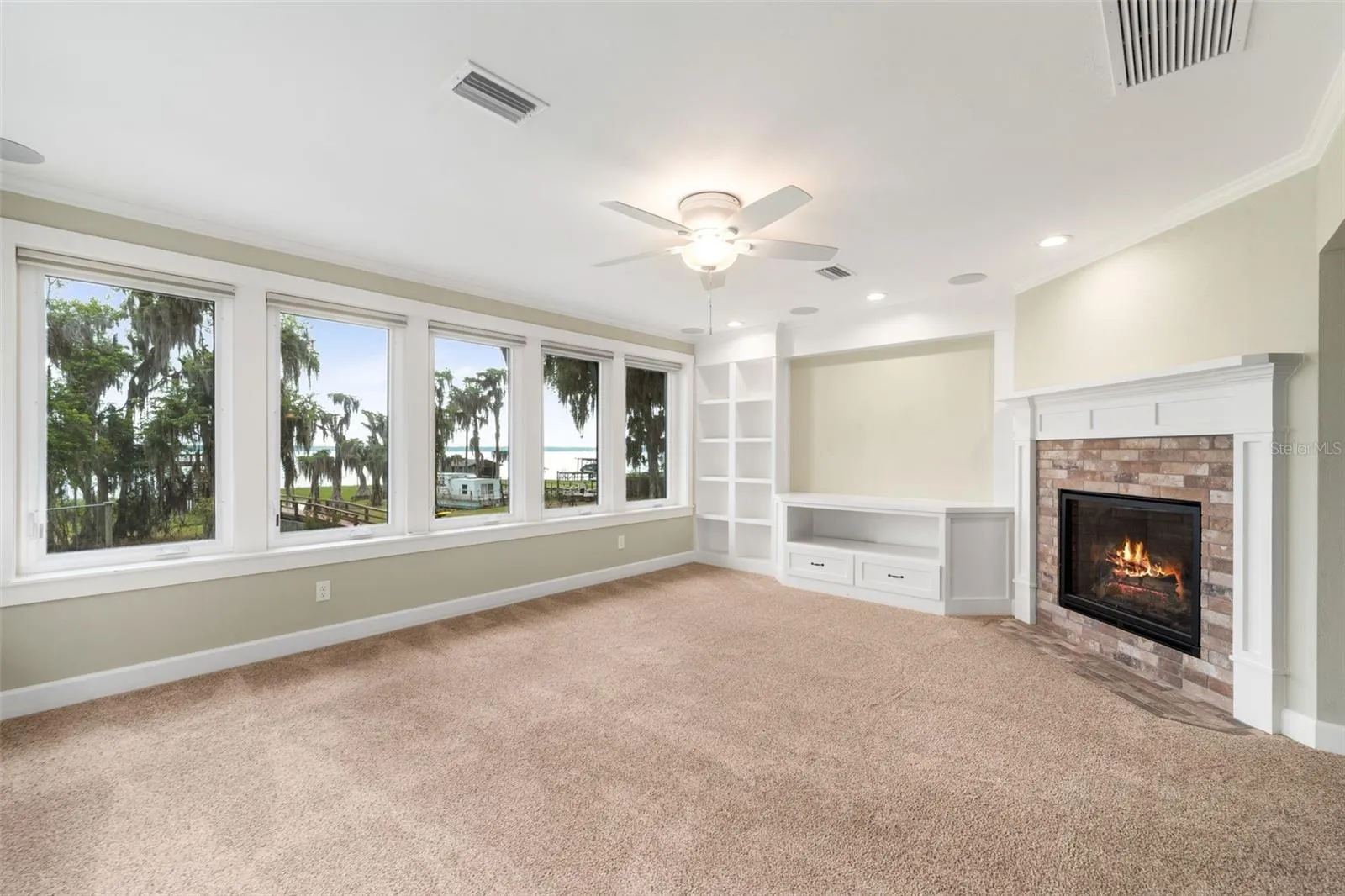 Family room with gas fireplace 2nd floor. View is to lake.