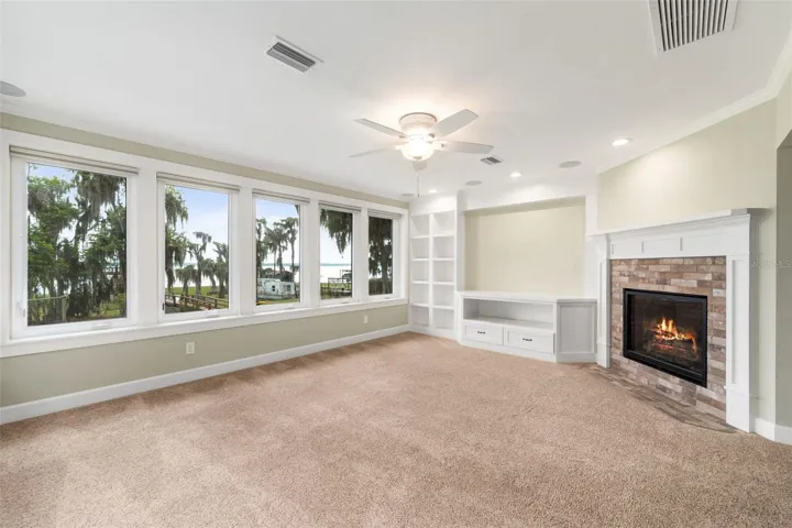 Family room with gas fireplace 2nd floor. View is to lake.
