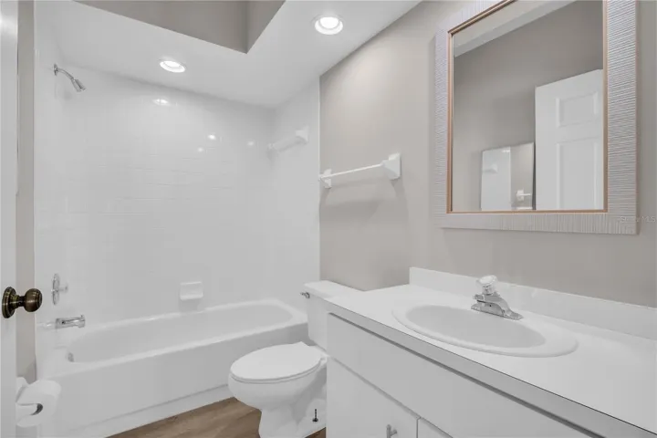The guest bath sits convenient to the other bedrooms ~