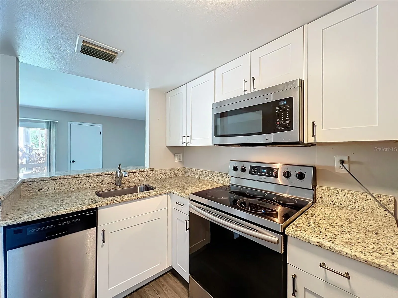 Kitchen with Granite Counter Top and Stainless Steel Appliances