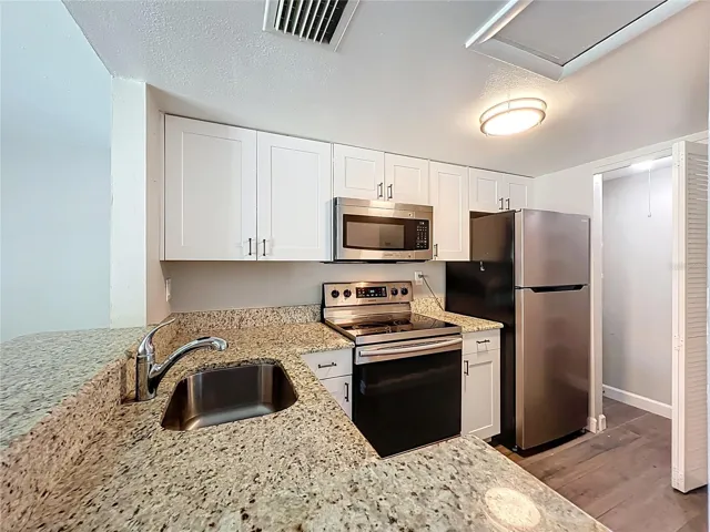 Kitchen with Granite Counter Top and Stainless Steel Appliances