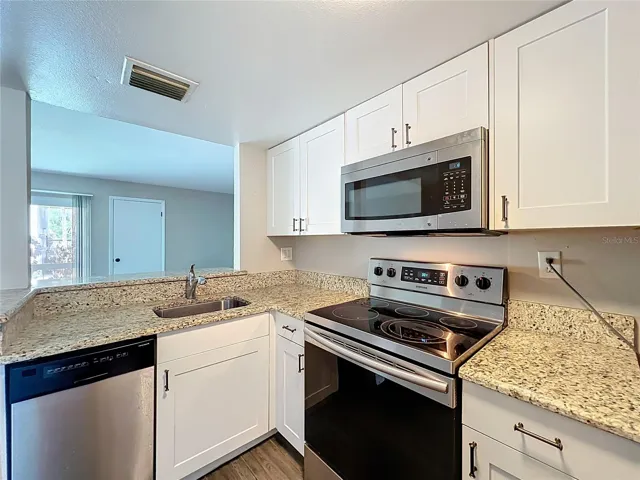 Kitchen with Granite Counter Top and Stainless Steel Appliances