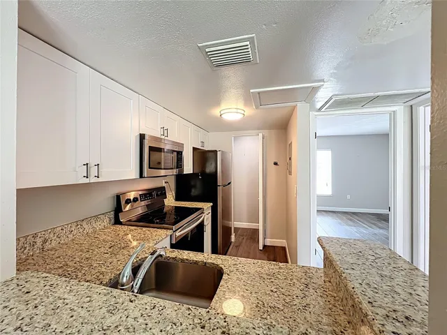 Kitchen with Granite Counter Top and Stainless Steel Appliances