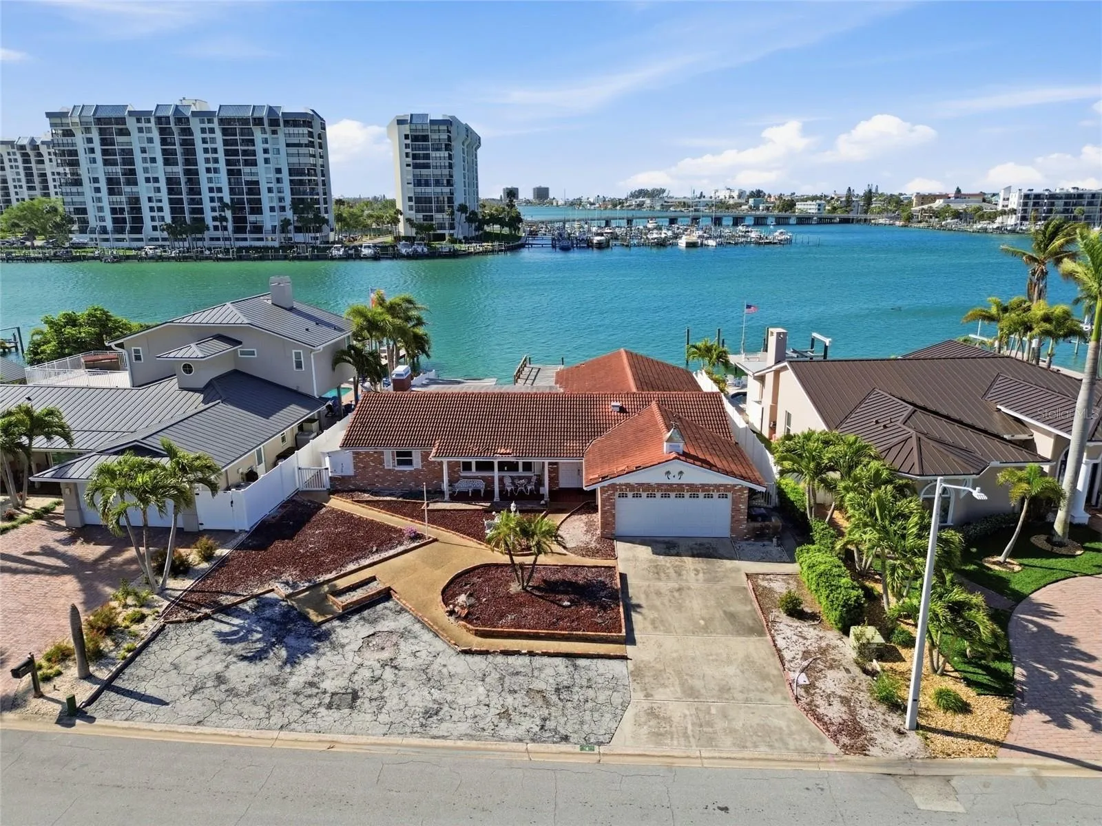 Drone shot of existing structure on 4 Bellevue Dr looking south at The Devil's Elbow on the Intracoastal and the one bridge to the Gulf of Mexico in the foreground on the right.