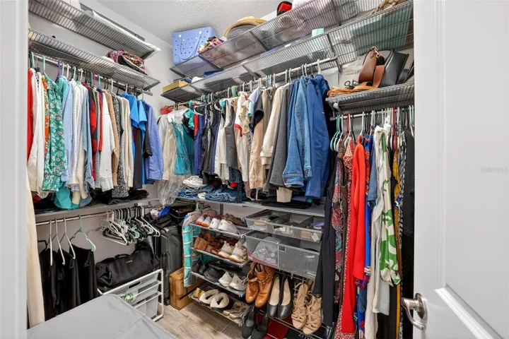 Primary Walk-In Closet with Custom Shelving