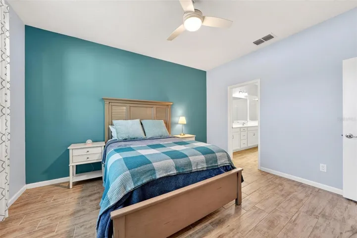 Right of bed is the primary en-suite bath and walk in closet