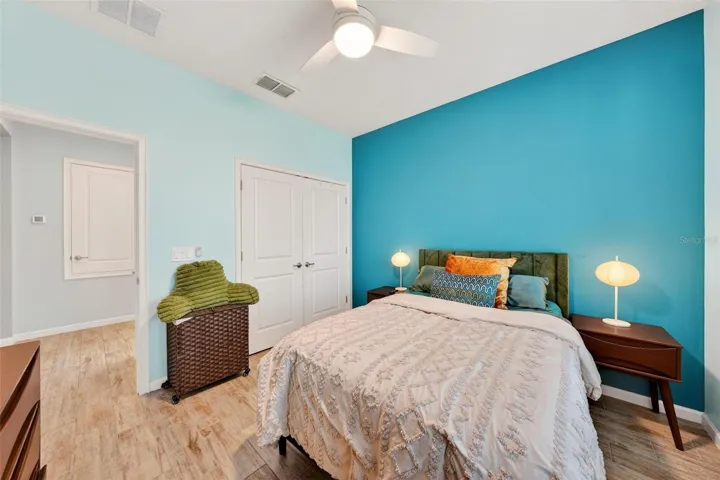 View of closet doors and hallway outside of bedroom to hall bathroom