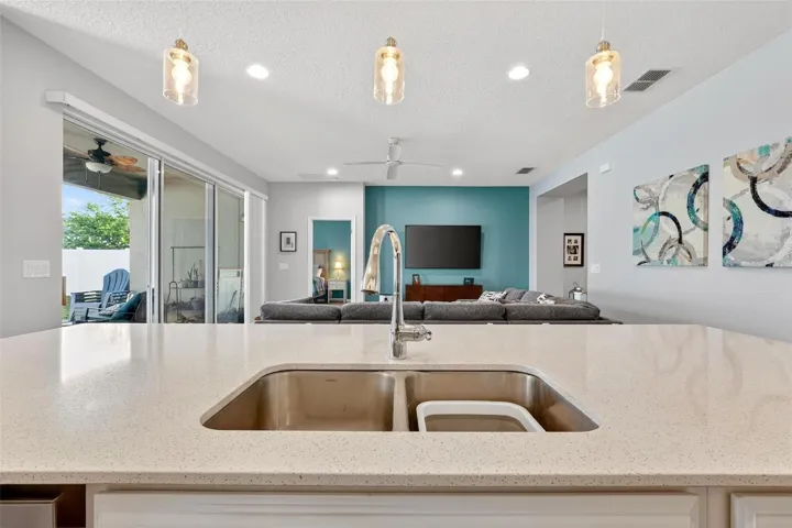 View from Kitchen showing family room and slider to patio
