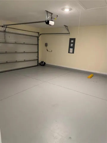Garage with pull down stairs to attic, walls painted and floor painted