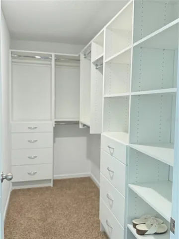 Master walk in closet with built in shelving