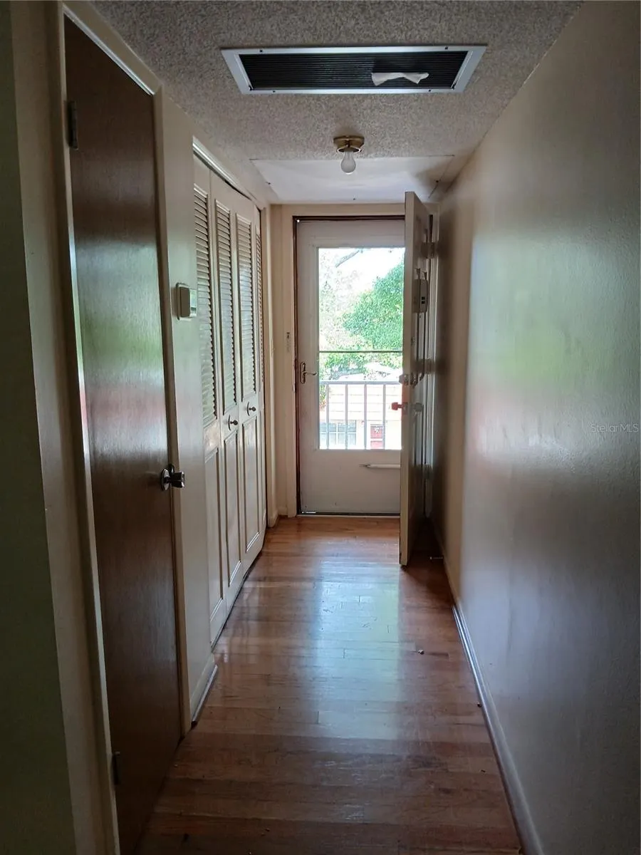 Entry hallway from the inside showing the nearly full glass storm door that locks proving light and security.