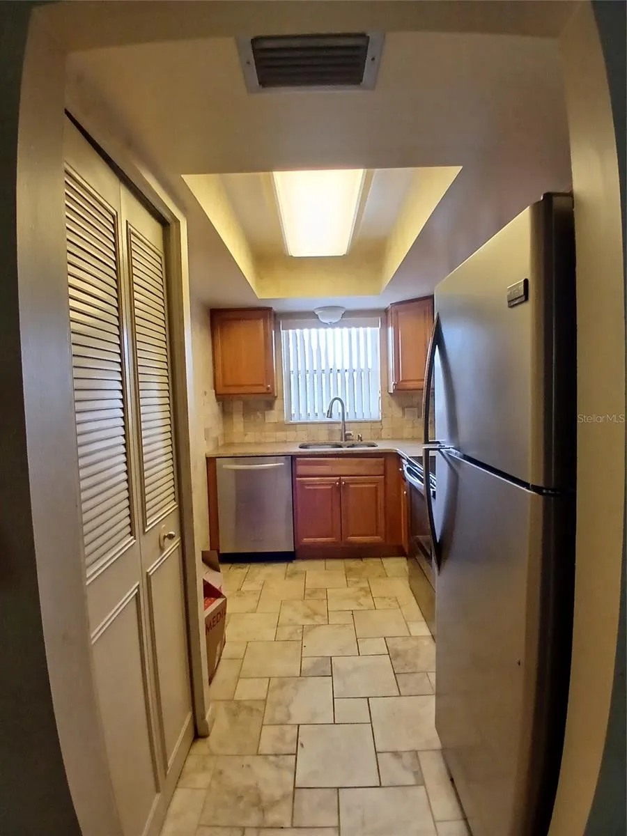 Entry to the kitchen. On the left is a 2 door reach in pantry.