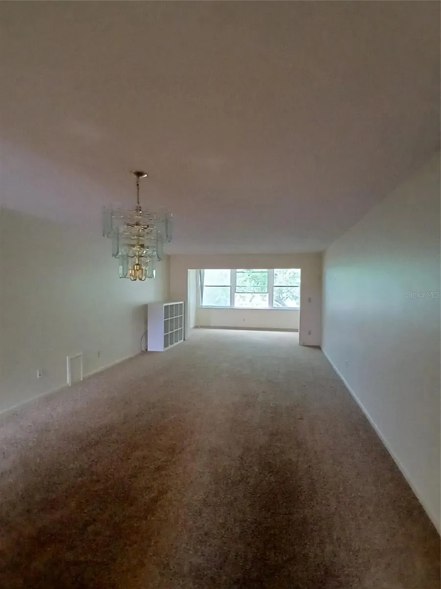 full living room with bonus room at the back.