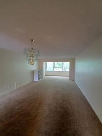 full living room with bonus room at the back.