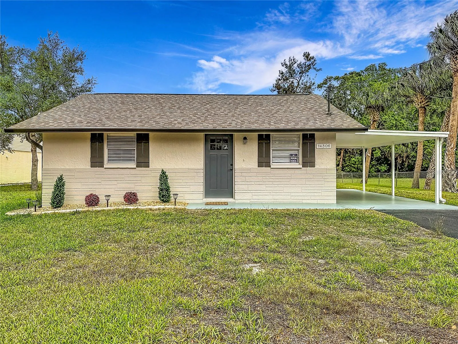 Exterior front with rain gutters and New Roof!
