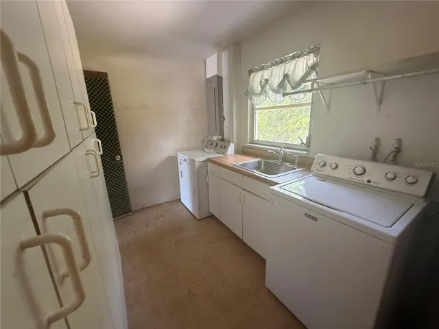 Inside laundry room with cabinetry