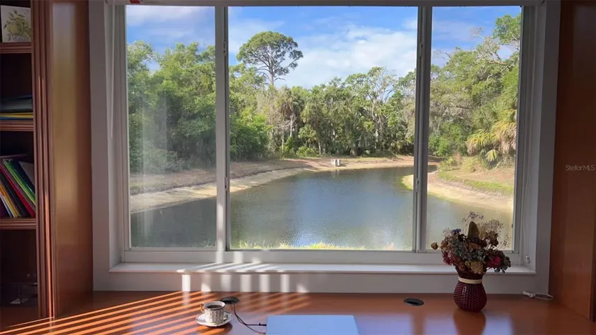 WINDOW WITH LAKE VIEW FILLS ROOM WITH LIGHT.