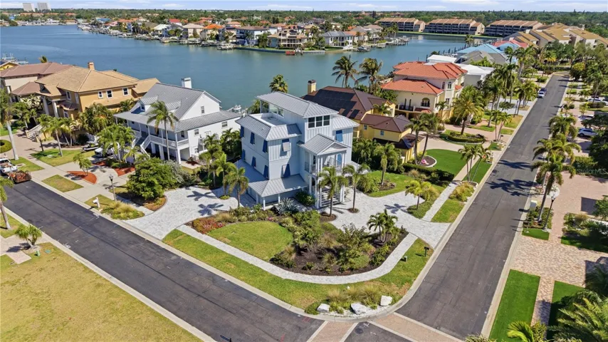 Exceptional coastal home on a prime corner lot in PYCC, offering beautiful water views and lush tropical landscaping. Elevated design, metal roof, and a commanding presence make this waterfront property truly stand out.