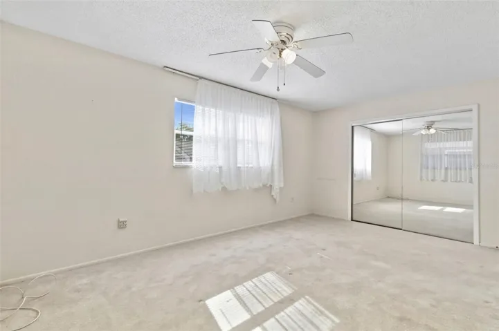 Mirrored closet doors are found on the spacious closet.