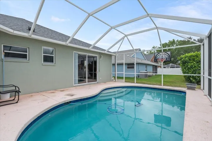 Relax in the screened backyard pool!
