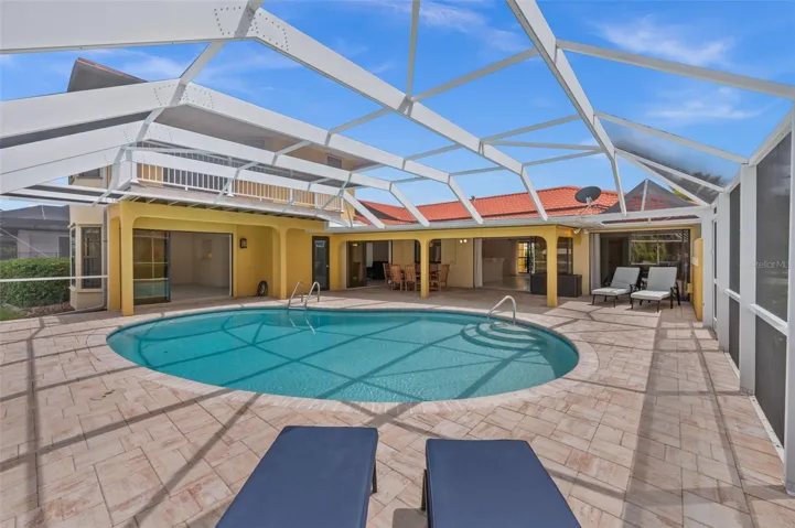 Lounging space surrounds the oversized, solar heated pool